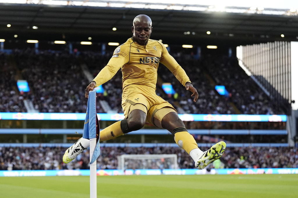 Crystal Palace's Jean-Philippe Mateta kicks the corner flag as he celebrates scoring their side's first goal from a penalty during the English Premier League soccer match between Aston Villa and Crystal Palace at Villa Park, Birmingham, England, Sunday, Aug. 31, 2025. (Nick Potts/PA via AP)