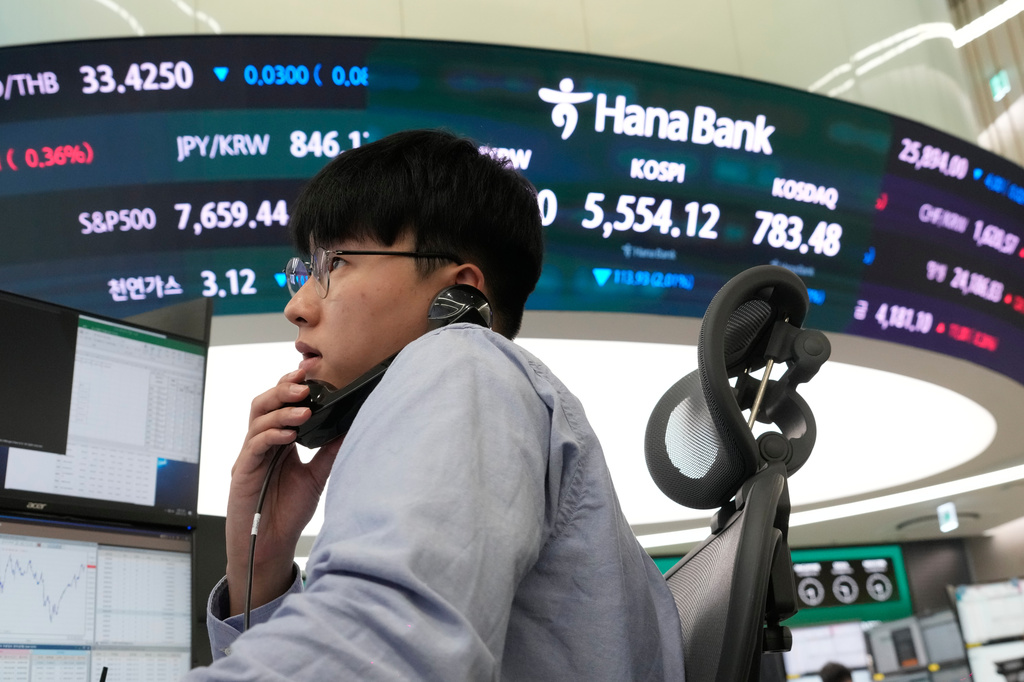 A currency trader talks on the phone at the foreign exchange dealing room of the Hana Bank headquarters in Seoul, South Korea, Monday, Oct. 19, 2026. (AP Photo/Ahn Young-joon)