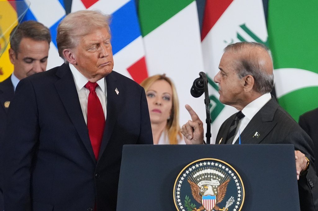 FILE - President Donald Trump, left, listens as Pakistan's Prime Minister Shehbaz Sharif speaks during a summit to support ending the more than two-year Israel-Hamas war in Gaza after a breakthrough ceasefire deal, on Oct. 13, 2025, in Sharm El Sheikh, Egypt. (AP Photo/Evan Vucci, File)