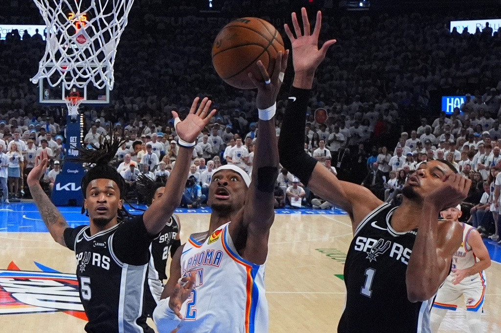 Oklahoma City Thunder guard Shai Gilgeous-Alexander (2) shoots against San Antonio Spurs forward Victor Wembanyama (1) in the second half of Game 5 in the Western Conference finals NBA basketball playoffs series, Tuesday, May 26, 2026, in Oklahoma City. (AP Photo/Julio Cortez)