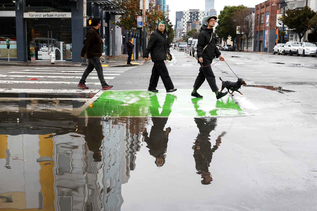 Heavy rains cause flooding in the streets of San Francisco, Monday, Dec. 22, 2025, as a storm system pummels Northern California. (Jessica Christian/San Francisco Chronicle via AP)