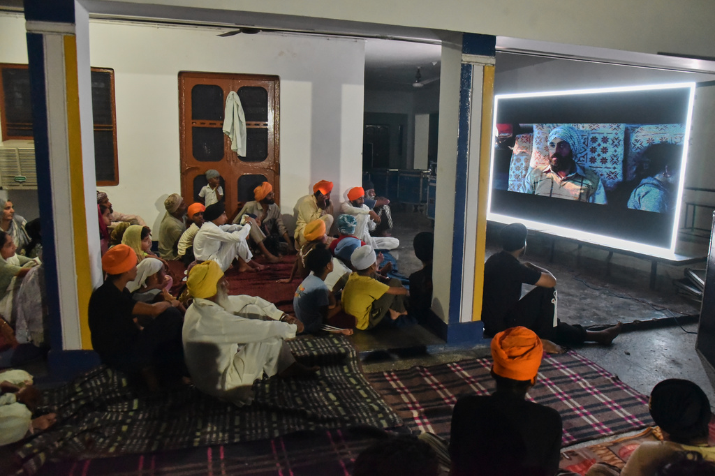 Villagers watch a special screening of the film “Satluj” at a Sikh temple at Tatley village, in Punjab's Gurdaspur district, India, Wednesday, July 8, 2026. (AP Photo/Prabhjot Gill)