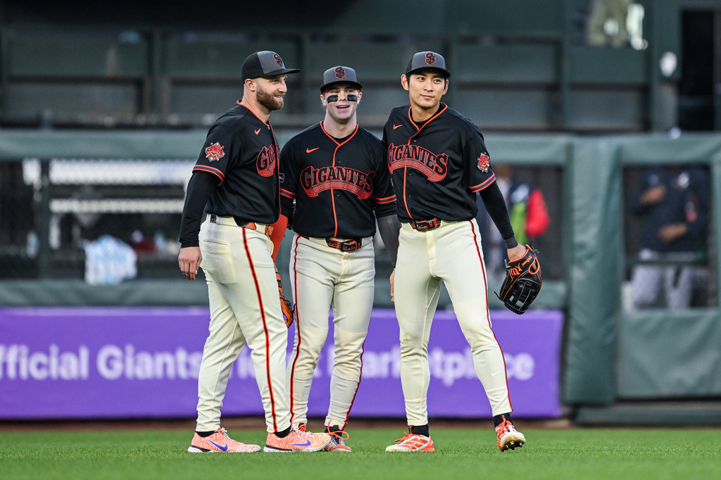 San Francisco Giants Casey Schmitt (10), Drew Gilbert (0) and Jung Hoo Lee (51) celebrate after their win against the Atlanta Braves in a baseball game, Saturday, June 27, 2026, in San Francisco (AP Photo/Justine Willard)