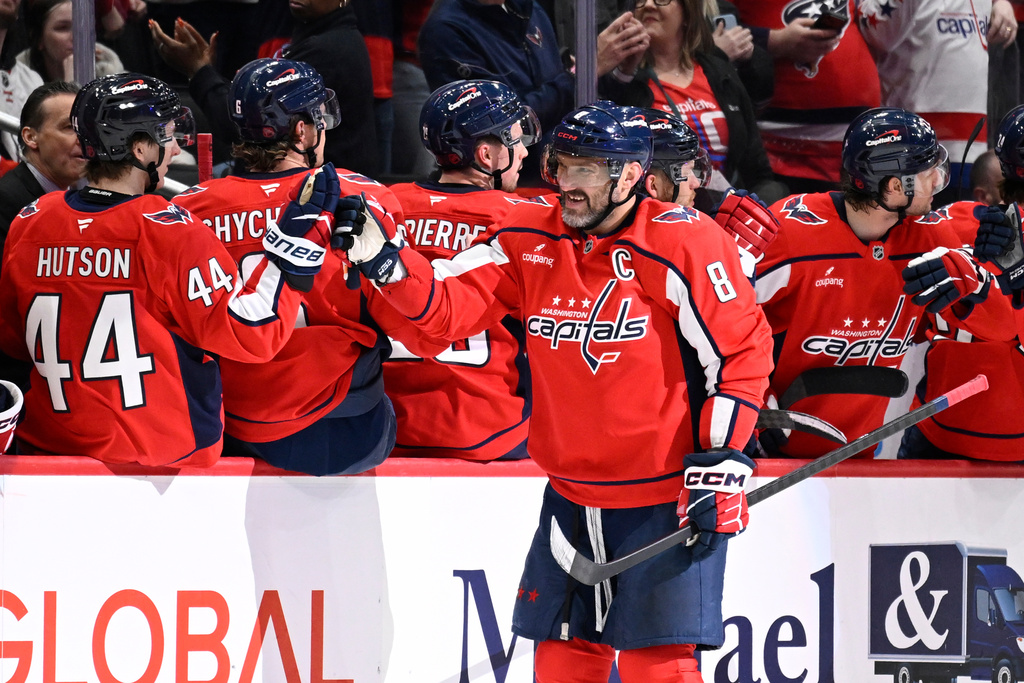 Washington Capitals left wing Alex Ovechkin (8) celebrates his goal with the bench during the second period of an NHL hockey game against the Ottawa Senators, Wednesday, March 18, 2026, in Washington. (AP Photo/John McDonnell)