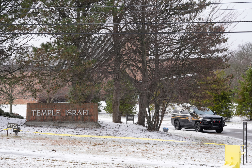 A police vehicle sits outside the Temple Israel synagogue Friday, March 13, 2026, in West Bloomfield Township, Mich. (AP Photo/Paul Sancya)