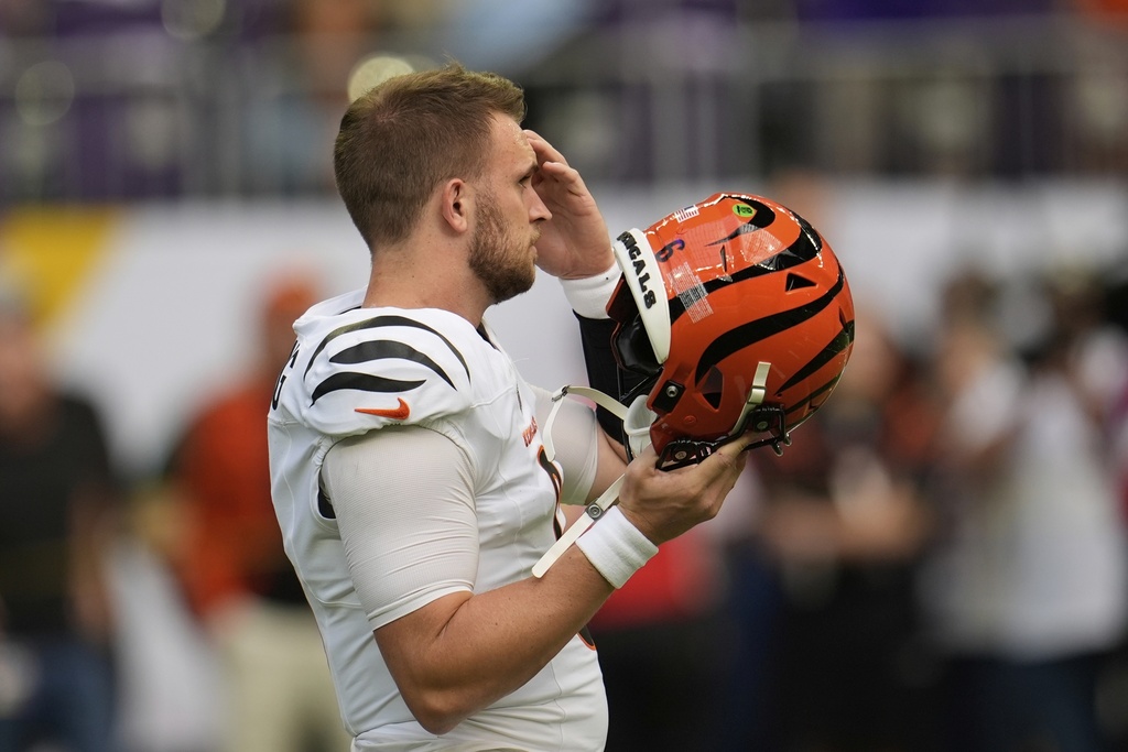 Cincinnati Bengals quarterback Jake Browning puts on his helmet before an NFL football game against the Minnesota Vikings, Sunday, Sept. 21, 2025, in Minneapolis. (AP Photo/Mike Stewart)