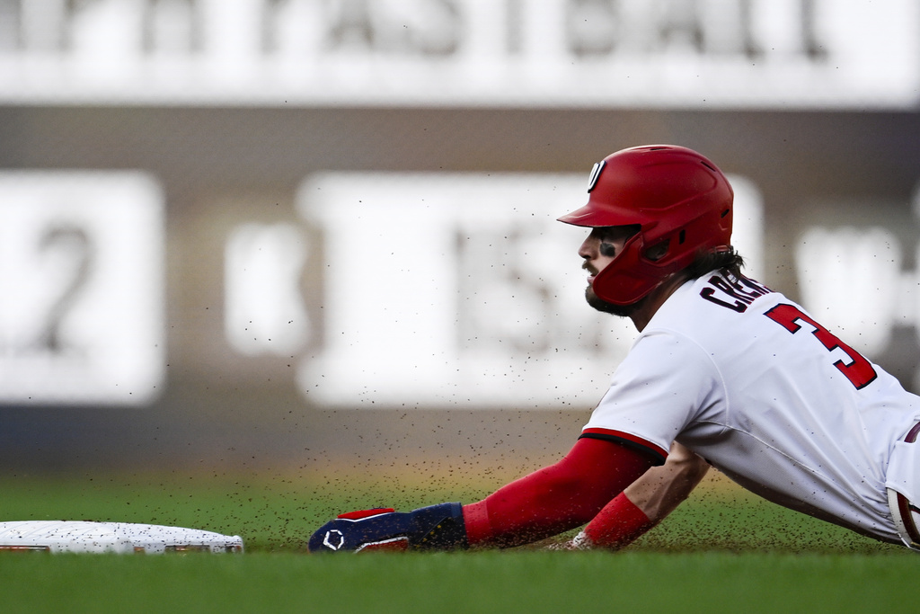 Washington Nationals' Dylan Crews slides into second base for a steal during the first inning of a baseball game against the Philadelphia Phillies, Thursday, Aug. 14, 2025, in Washington. (AP Photo/Terrance Williams)