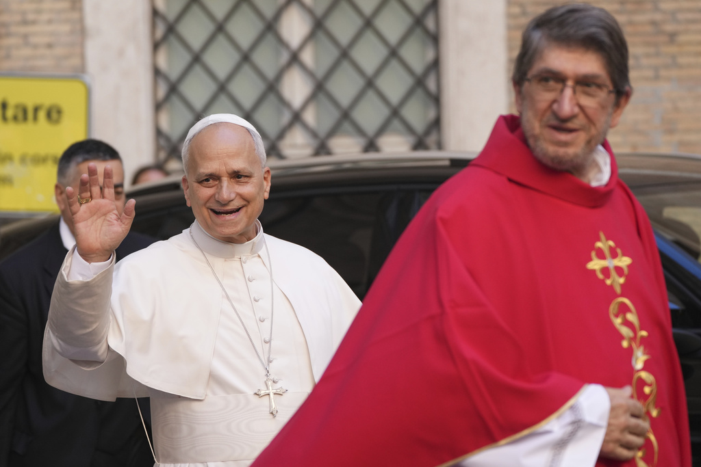 Pope Leo XIV waves flanked by Alejandro Moral Antón, Order of Saint Augustine prior, upon his arrivial at the St. Augustin Basilica in Rome, Monday, Sept. 1, 2025, to address his fellow Augustinians at the start of their global assembly. (AP Photo/Domenico Stinellis)
