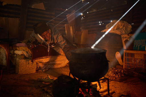 FILE - Matli Monyamane cooks a meal in Ha Lejone, Lesotho, July 22, 2025. (AP Photo/Bram Janssen, File) FILE - Matli Monyamane cooks a meal in Ha Lejone, Lesotho, July 22, 2025. (AP Photo/Bram Janssen, File)