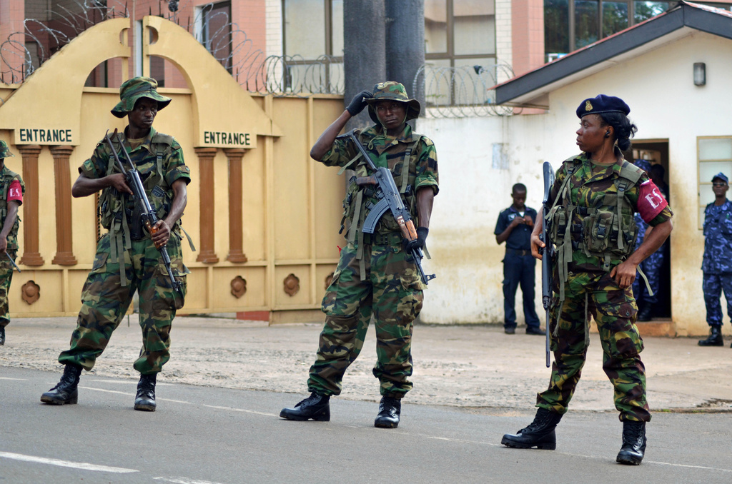 FILE - Soldiers stand guard in Freetown, Sierra Leone, Nov. 23, 2012. (AP Photo/Tommy Trenchard, File)