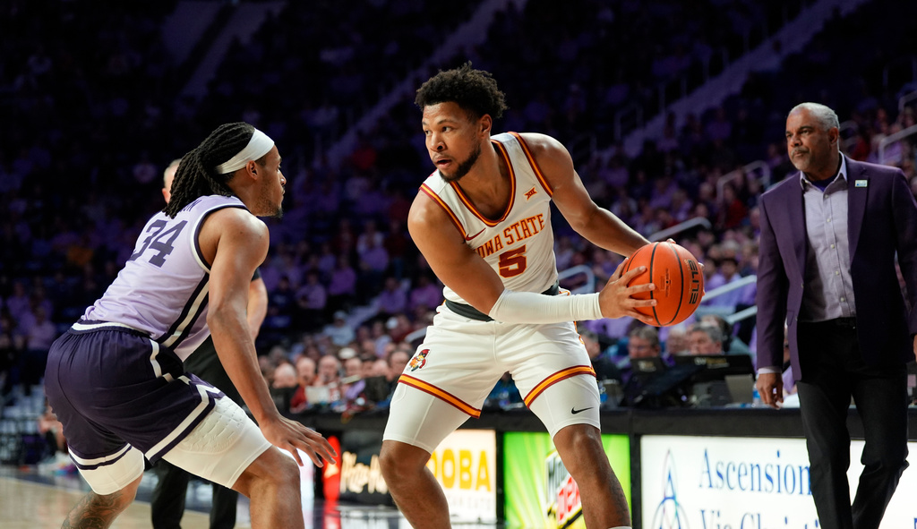 Iowa State forward Joshua Jefferson (5) looks to drive against Kansas State guard Nate Johnson (34) during the first half of an NCAA college basketball game, Sunday, Feb. 1, 2026, in Manhattan, Kan. (AP Photo/Nick Krug)