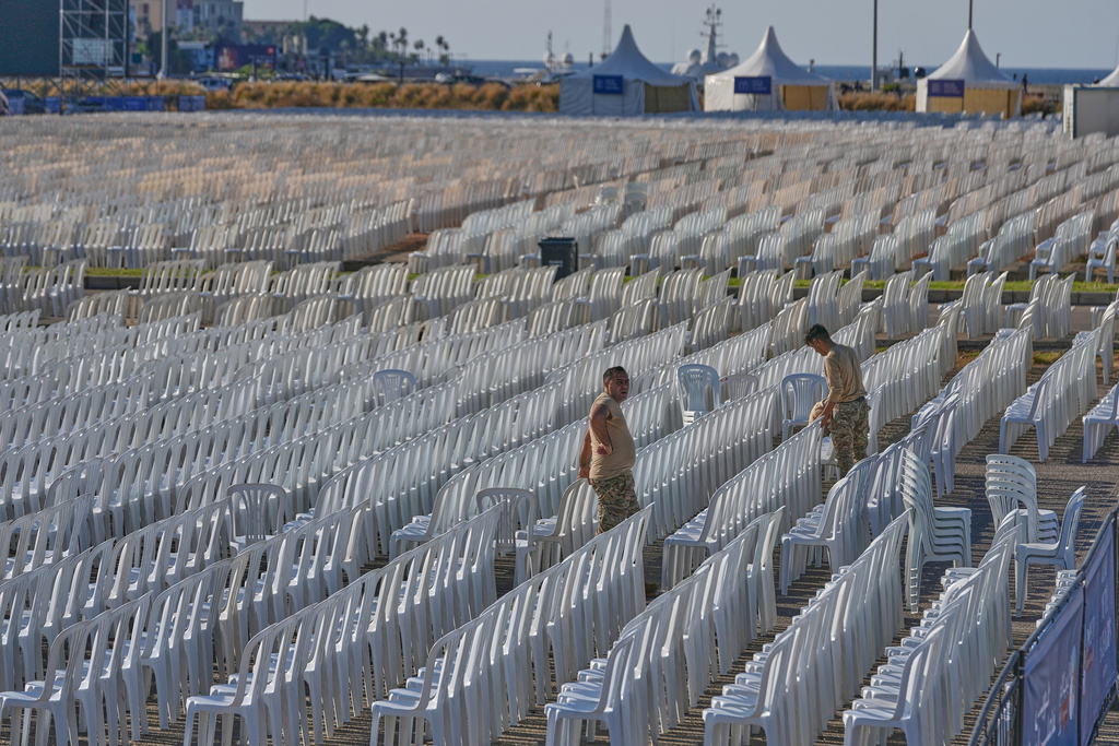 Lebanese army soldiers set chairs in preparation of the area where Pope Leo XIV will hold a Holy mass during his visit to Lebanon, at the waterfront of downtown Beirut, Thursday, Nov. 27, 2025. (AP Photo/Hussein Malla)