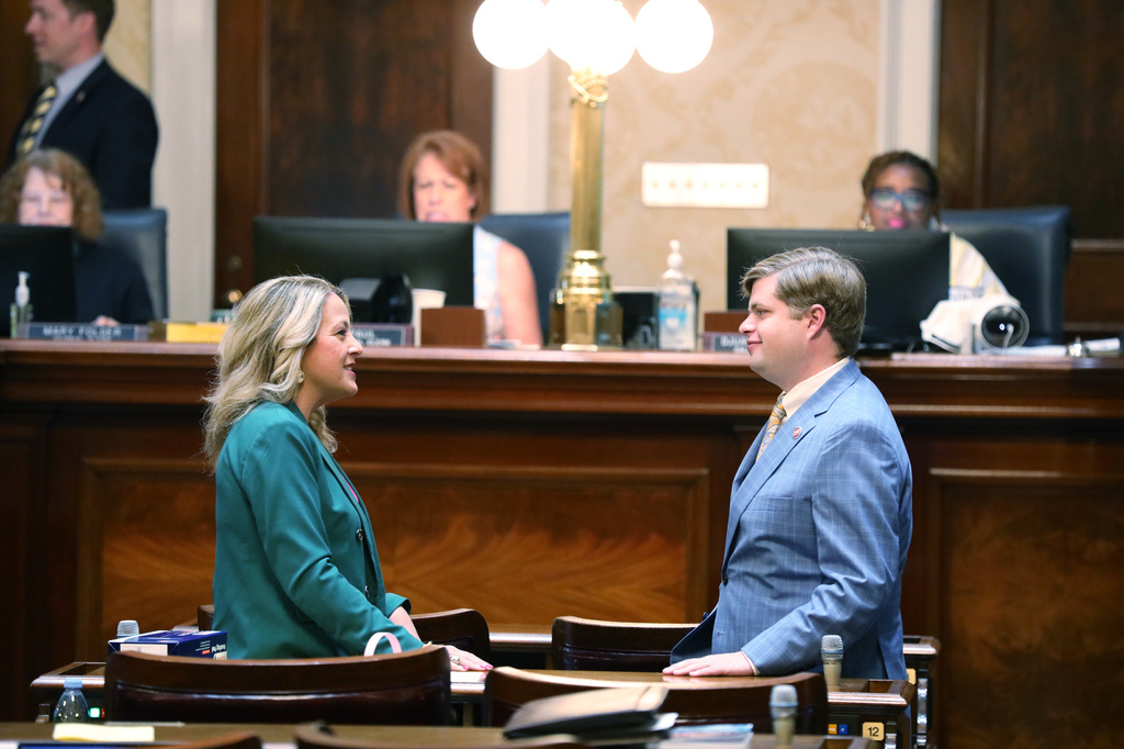 Republican South Carolina Reps. Melissa Oremus, left, and Brandon Newton, right, talk before the House session on redistricting on Monday, May 18, 2026, in Columbia, S.C. (AP Photo/Jeffrey Collins)