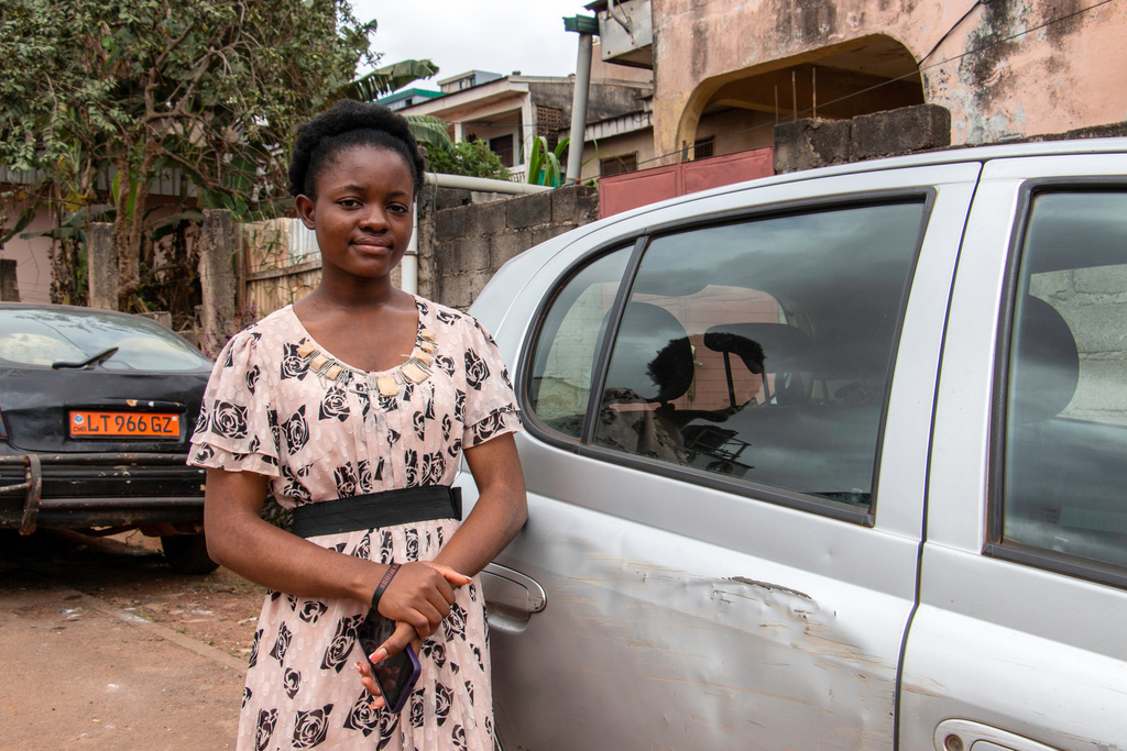 Neh Favour Wenazie, a student at the Advanced School of Mass Communication, poses in the Acacia neighborhood, Yaoundé, Cameroon, Sept. 12, 2025. (AP Photo / Welba Yamo Pascal)