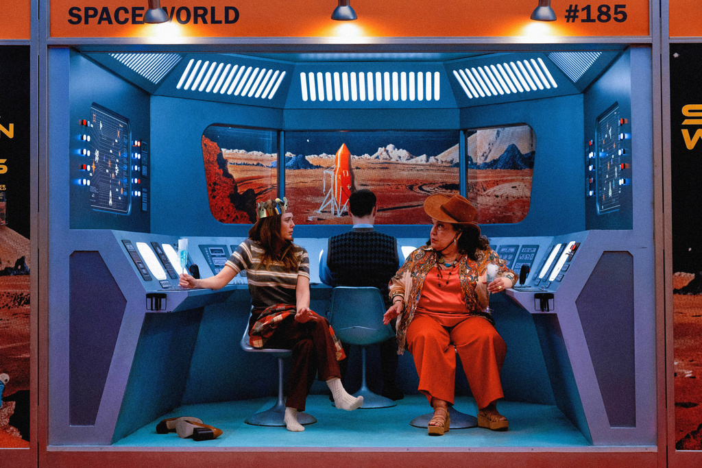 This image released by A24 shows Elizabeth Olsen, left, and Olga Merediz in a scene from "Eternity." (A24 via AP)