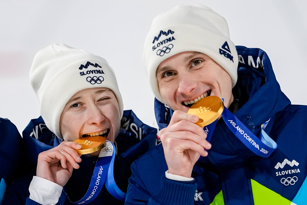 Siblings Nika Prevc, and Domen Prevc, of Slovenia, pose after winning the gold medal in the ski jumping mixed team competition at the 2026 Winter Olympics, in Predazzo, Italy, Tuesday, Feb. 10, 2026. (AP Photo/Matthias Schrader)
