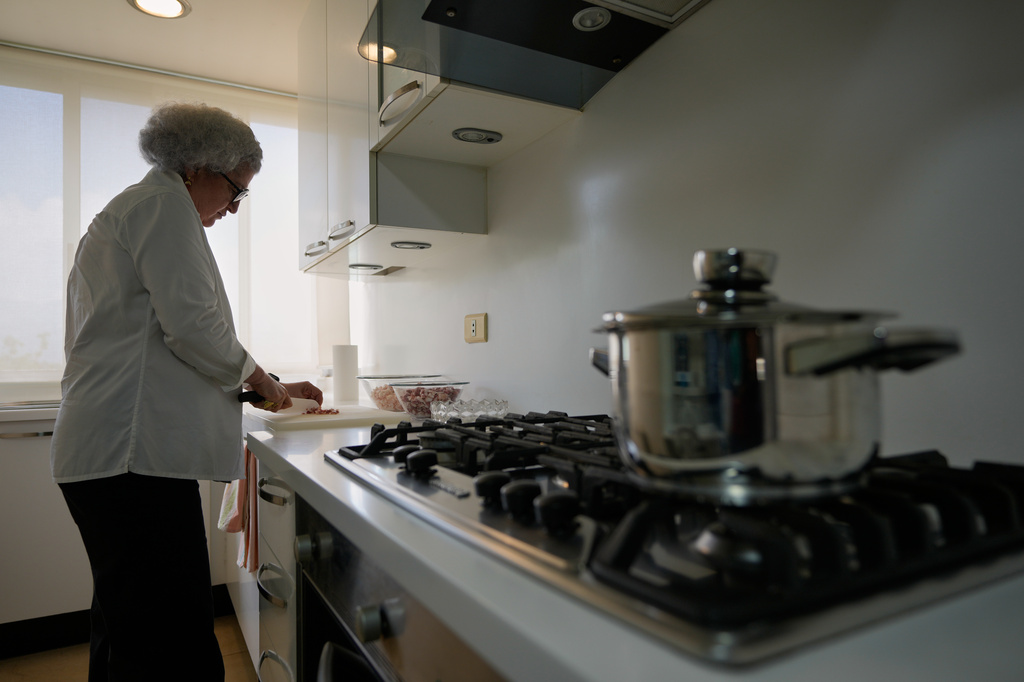 Anissa Helou, 74, one of the Middle East's most acclaimed cooks and food writers, prepares awarma, a traditional Lebanese lamb confit, at her late mother's apartment in the Mount Lebanon town of Ballouneh, Thursday, July 2, 2026. (AP Photo/Hussein Malla)