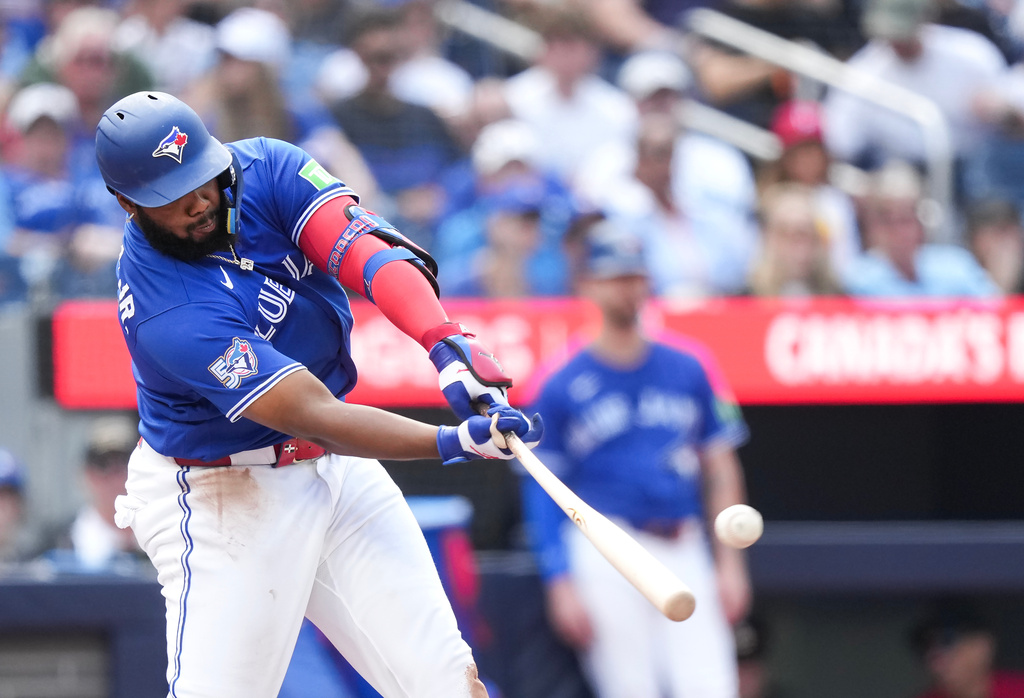 Toronto Blue Jays' Vladimir Guerrero Jr. hits a solo home run while playing against the Baltimore Orioles during the fifth inning of a baseball game in Toronto, Sunday, Sept. 13, 2026. (Nathan Denette/The Canadian Press via AP)