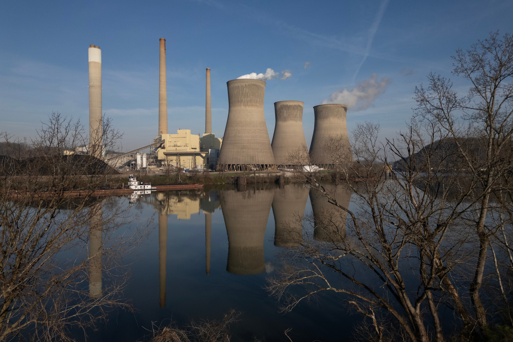FILE - American Electric Power's John Amos coal-fired power plant operates in Winfield, W.Va., across the Kanawha River from Poca, W.Va., March 22, 2026. (AP Photo/Carolyn Kaster, File)