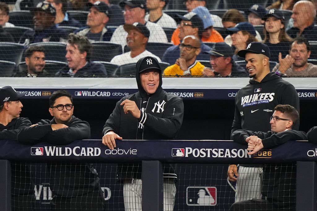 New York Yankees' Aaron Judge, center, watches the game from the dugout railing during the sixth inning in Game 2 of baseball's American League Wild Card Series against the Boston Red Sox, Wednesday, Sept. 30, 2026, in New York. (AP Photo/Frank Franklin II)