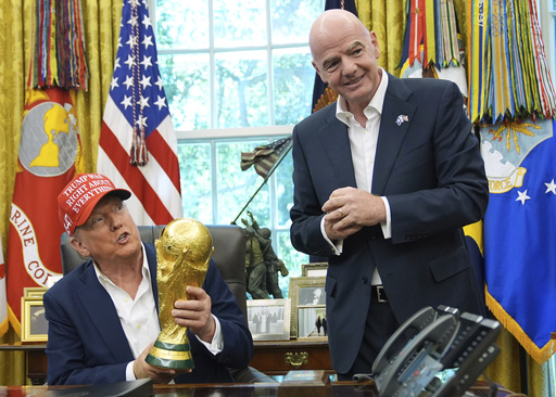 FILE - President Donald Trump holds the FIFA World Cup Winners Trophy as FIFA President Gianni Infantino looks on during an announcement in the Oval Office of the White House, Aug. 22, 2025, in Washington. (AP Photo/Jacquelyn Martin, File) FILE - President Donald Trump holds the FIFA World Cup Winners Trophy as FIFA President Gianni Infantino looks on during an announcement in the Oval Office of the White House, Aug. 22, 2025, in Washington. (AP Photo/Jacquelyn Martin, File)