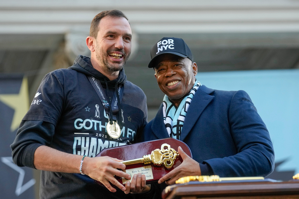 Gotham Football Club coach Juan Carlos Amoros receives a key to the city from Mayor Eric Adams curing a ceremony celebrating the team's win over the Washington Spirit for the NWSL championship, Monday, Nov. 24, 2025, in New York. (Michael Appleton/New York City Mayor's Office via AP)