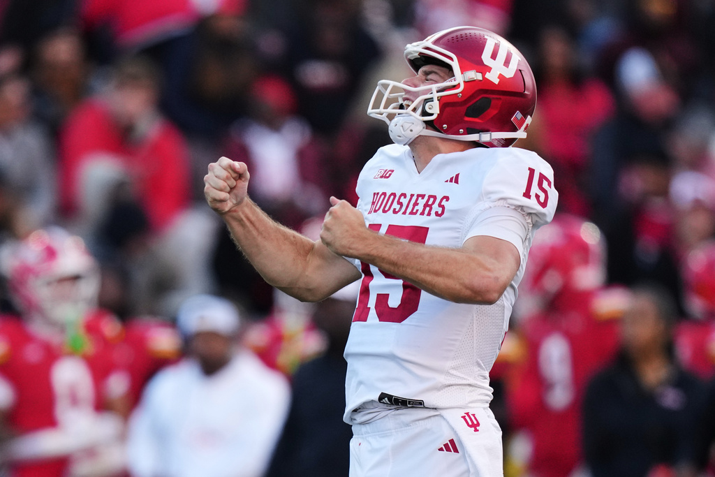 FILE - Indiana quarterback Fernando Mendoza (15) celebrates after throwing a touchdown pass to wide receiver Omar Cooper Jr. during the first half of an NCAA college football game against Maryland, Saturday, Nov. 1, 2025, in College Park, Md. (AP Photo/Stephanie Scarbrough, File)
