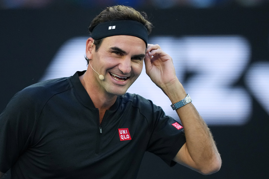 FILE - Roger Federer of Switzerland reacts with partner Andre Agassi of the United States in their doubles match against Lleyton Hewitt and Pat Rafter of Australia during the Opening Ceremony for the Australian Open tennis championship in Melbourne, Australia, Jan. 17, 2026. (AP Photo/Aaron Favila, File)