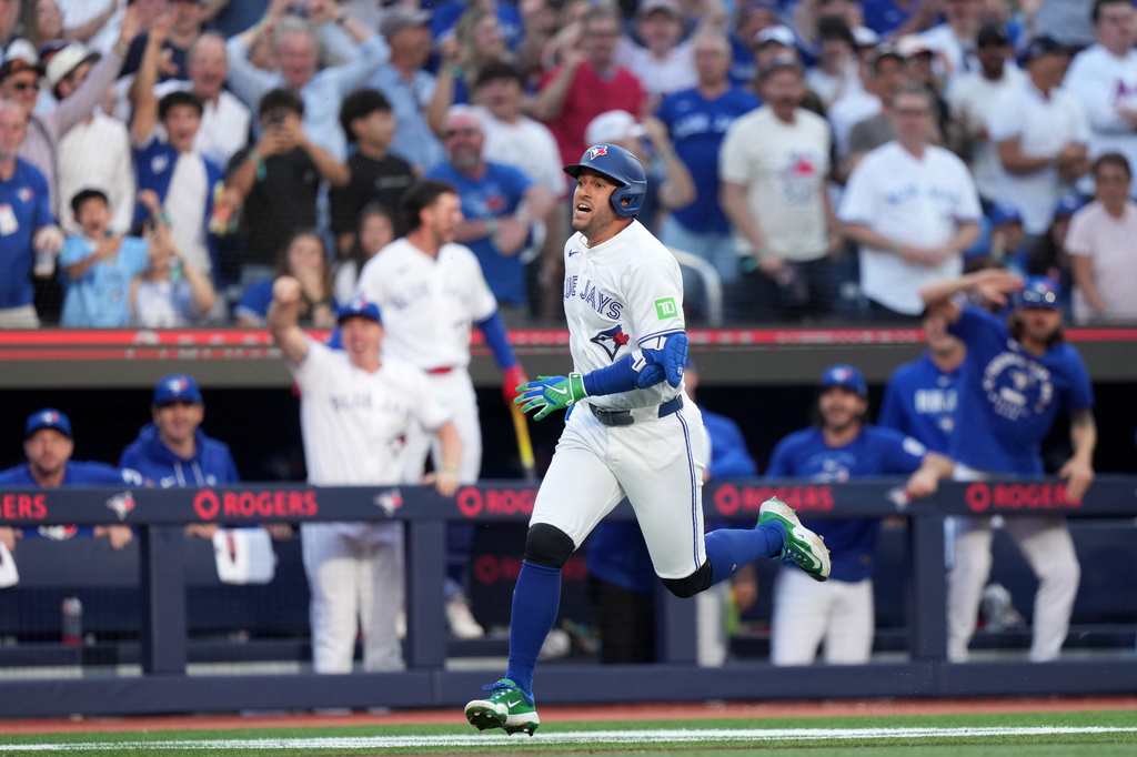 Toronto Blue Jays designated hitter George Springer runs home after hitting a triple on an in-field home run after a fielding error by New York Mets' A.J. Ewing during the first inning of a baseball game in Toronto, Monday, June 29, 2026. (Nathan Denette/The Canadian Press via AP)