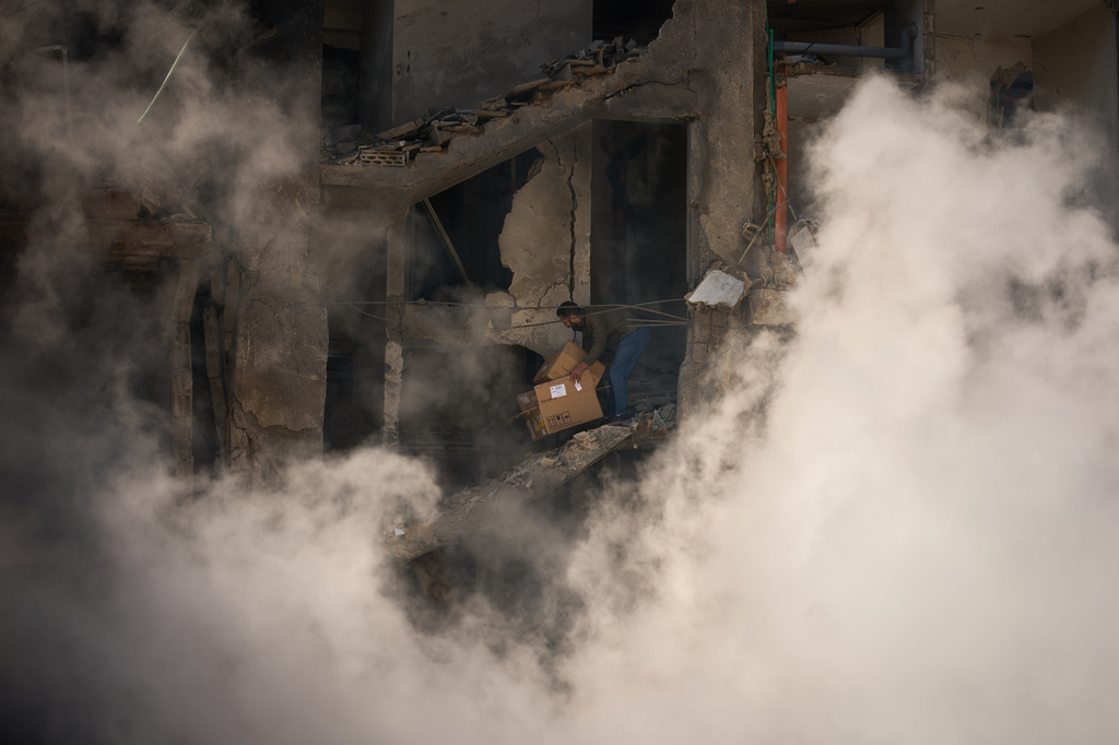 A man gathers his belongings from his home, which has been destroyed in an Israeli airstrike a day earlier in Beirut, Lebanon, Thursday, April 9, 2026. (AP Photo/Emilio Morenatti)