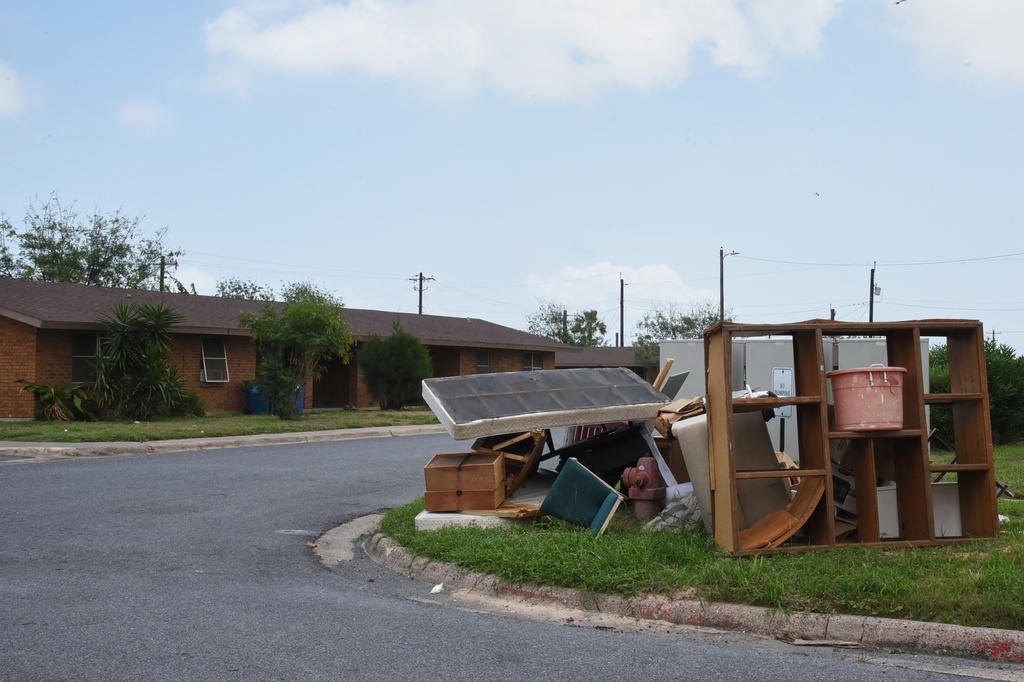 A pile of furniture is seen in a public housing subdivision in Port Isabel, Texas, on April 13, 2026. (AP Photo/Valerie Gonzalez)
