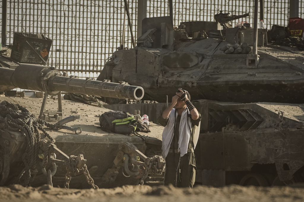 An Israeli soldier prays at a staging area on the border with Gaza Strip, as seen from southern Israel, Tuesday, Sept. 16, 2025. (AP Photo/Leo Correa)