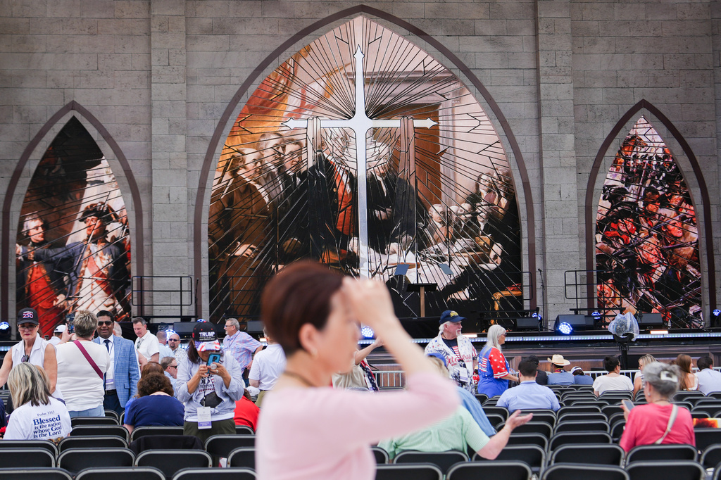 A person prays during Rededicate 250, a mostly conservative Christian prayer gathering in honor of the United States' 250th anniversary, on the National Mall, Sunday, May 17, 2026, in Washington. (AP Photo/Julia Demaree Nikhinson)