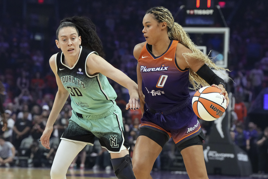 Phoenix Mercury forward Satou Sabally (0) shields the ball from New York Liberty forward Breanna Stewart (30) during the first half of Game 3 in the first round of the WNBA basketball playoffs, Friday, Sept. 19, 2025, in Phoenix. (AP Photo/Rick Scuteri)