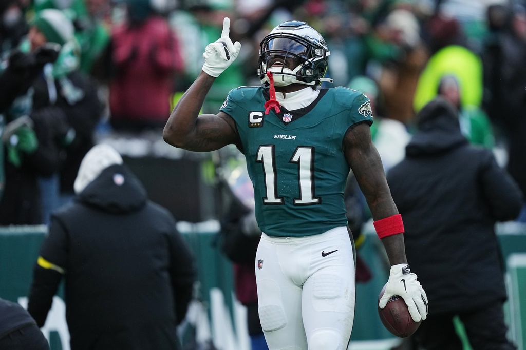 Philadelphia Eagles wide receiver A.J. Brown (11) celebrates scoring a touchdown during the second half of an NFL football game against the Las Vegas Raiders on Sunday, Dec. 14, 2025, in Philadelphia. (AP Photo/Matt Rourke)