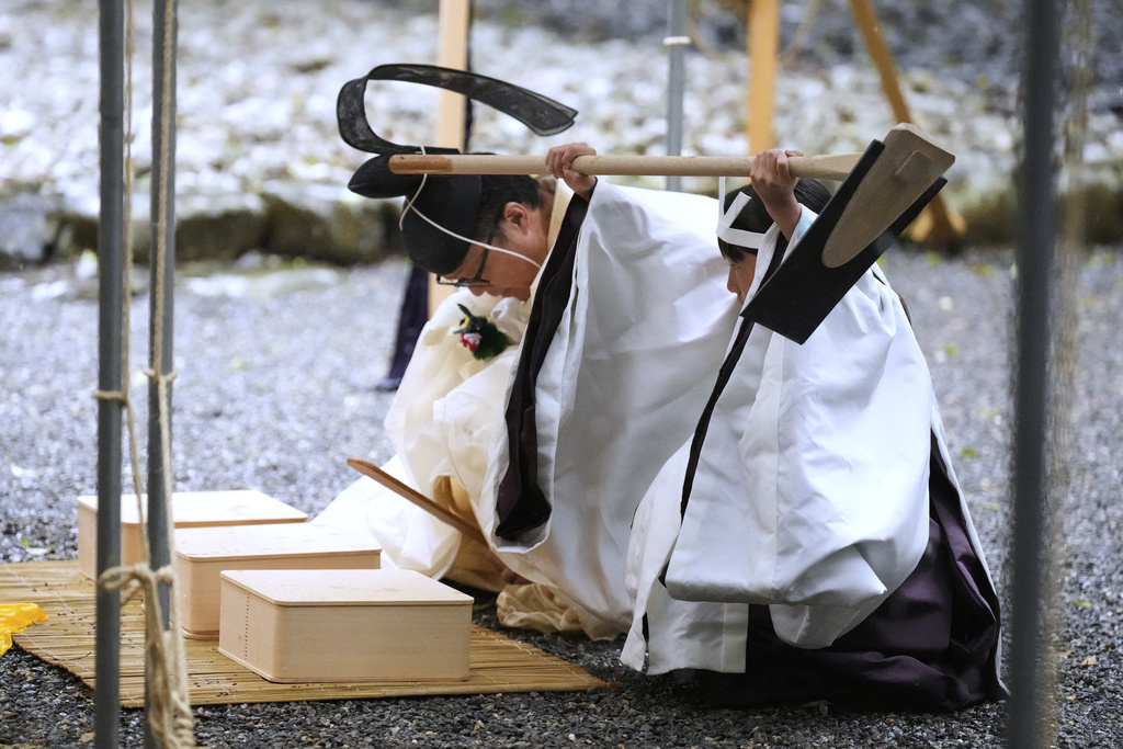 A Shinto priest and a girl called "monoimi" participate in Yamaguchisai, a kickoff ceremony of Shikinen Sengu, concluding in 2033, at Toyoukedaijingu, also known as Geku, or the outer sanctuary, of the Jingu shrine complex in Ise, central Japan, Friday, May 2, 2025. (AP Photo/Hiro Komae)