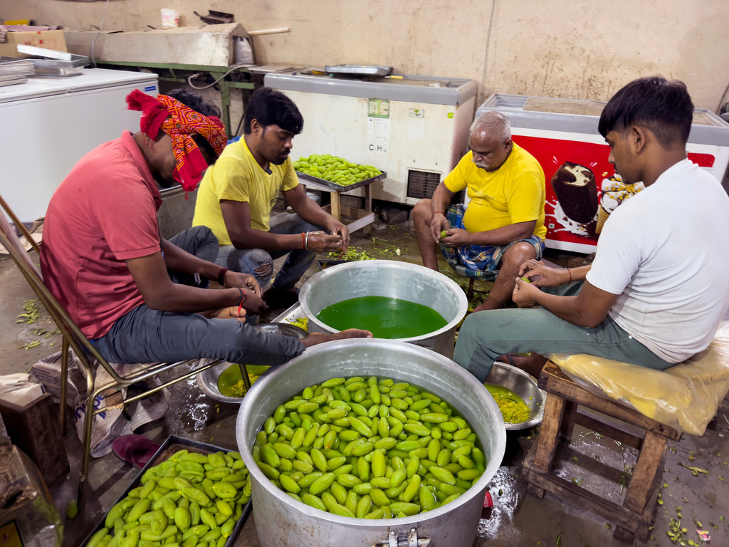 Workers making sweets at factory for Diwali, the festival of lights, in Chilbila Pratapgarh District, northern Indian state of Uttar Pradesh, Thursday, Oct. 16, 2025. (AP Photo/Rajesh Kumar Singh)