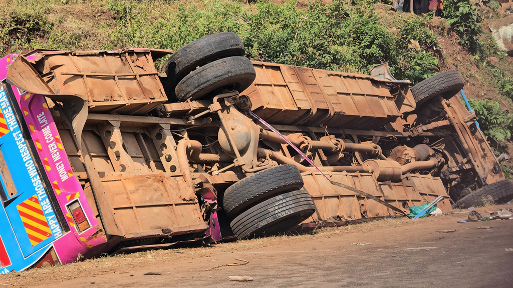 A bus lies on the side of the road Friday, July 17, 2026, after it crashed Thursday night in the the Kapchorwa District in eastern Uganda. (AP Photo)
