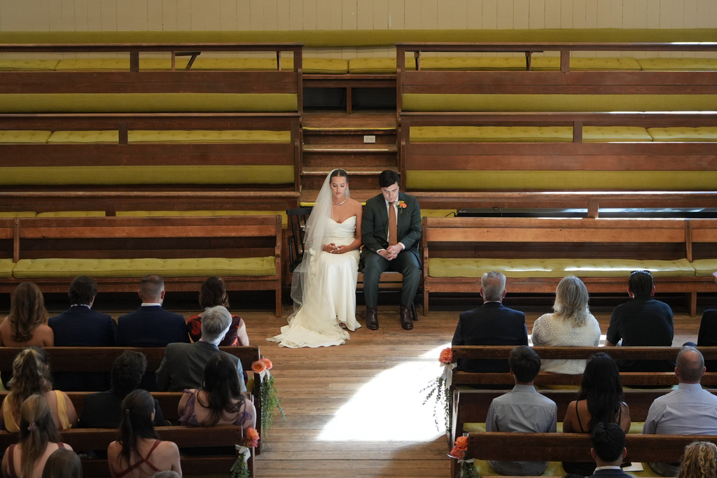 Emily Philbrook and Benjamin Barger hold a moment of silence during their traditional Quaker wedding at Arch Street Meeting House in Philadelphia on Oct. 3, 2025. (AP Photo/Luis Andres Henao)
