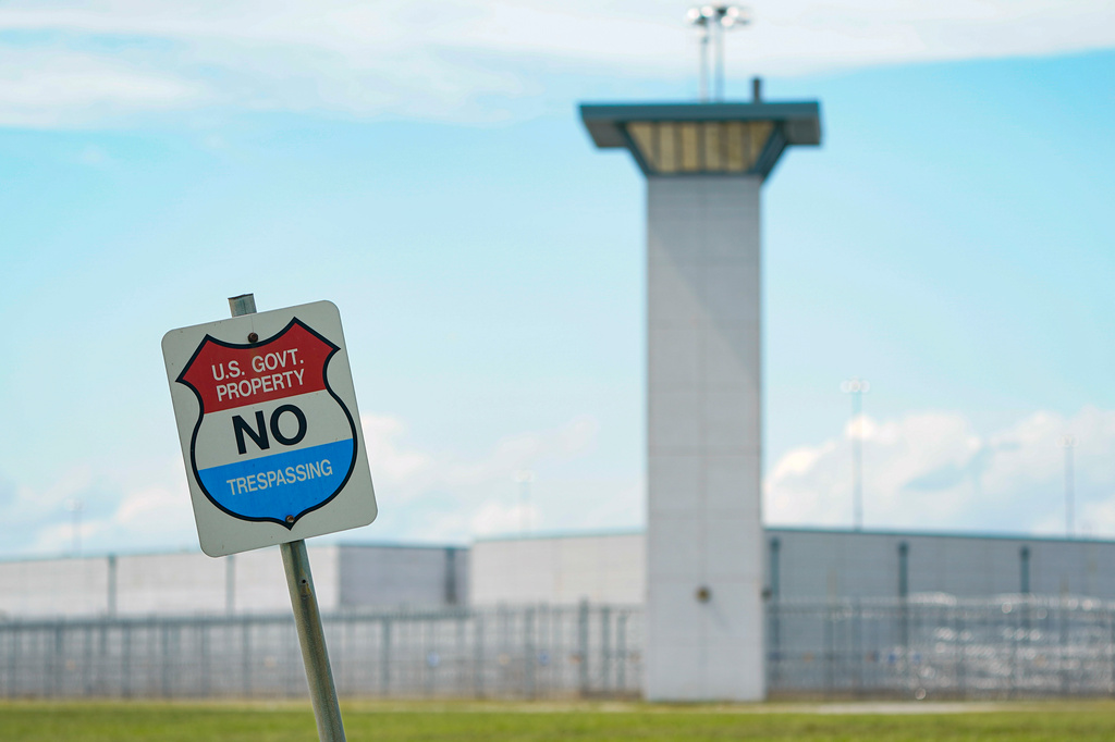 FILE - A no trespassing sign is displayed outside the federal prison complex in Terre Haute, Ind., Friday, Aug. 28, 2020. (AP Photo/Michael Conroy, File)