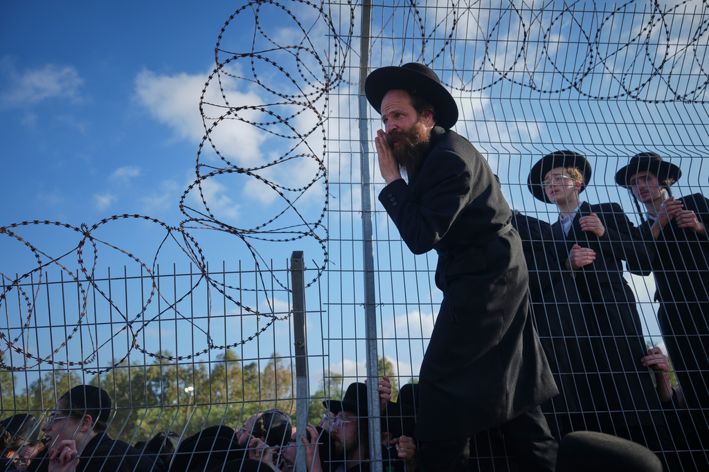 Ultra-Orthodox Jewish men protest against military recruitment and call for the release of detained draft resisters outside a military prison near Kfar Yona, Israel, Wednesday, June 17, 2026. (AP Photo/Ariel Schalit)