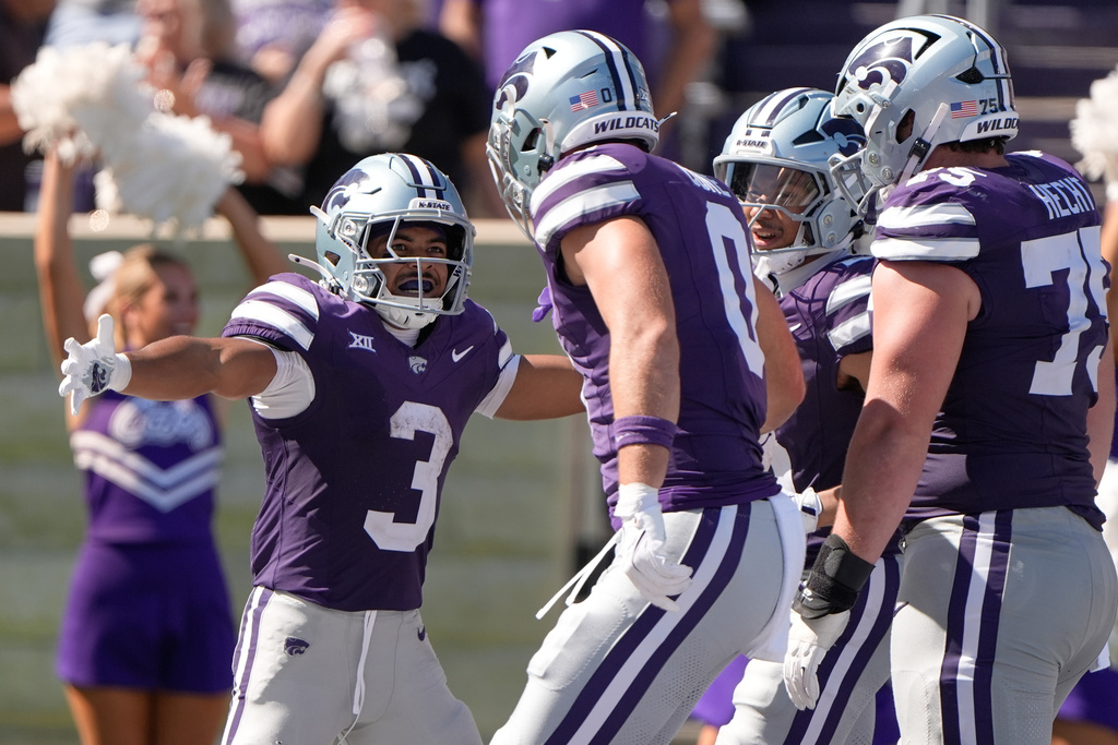 Kansas State running back Dylan Edwards (3) celebrates with teammates after scoring a touchdown during the second half of an NCAA college football game against Central Florida, Saturday, Sept. 27, 2025, in Manhattan, Kan. (AP Photo/Charlie Riedel)