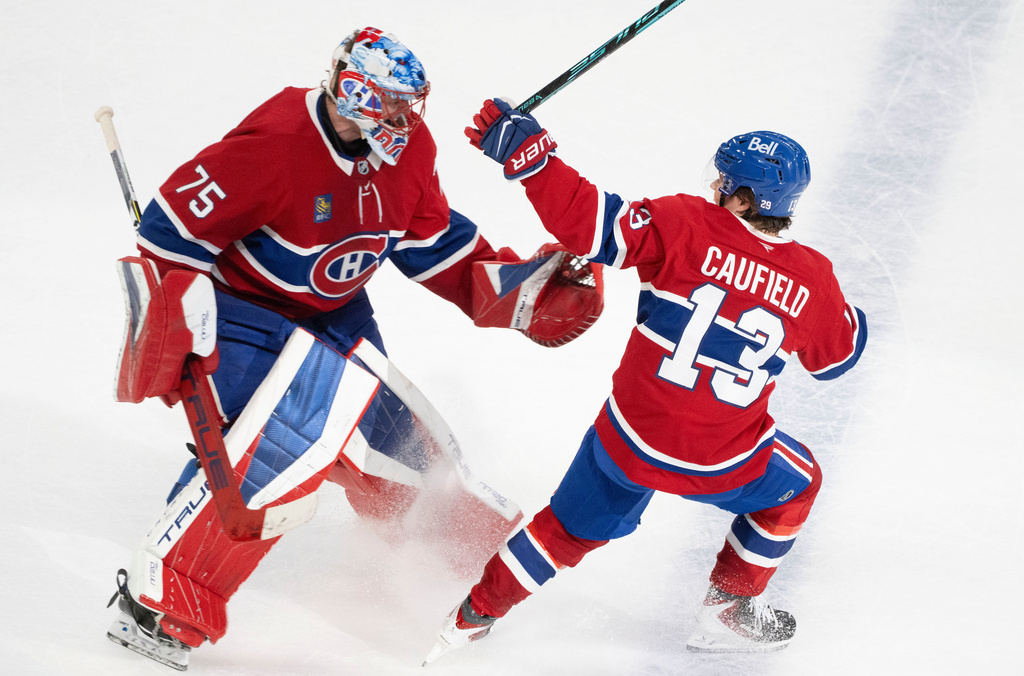 Montreal Canadiens' Cole Caufield (13) celebrates after his goal against the Nashville Predators with goaltender Jakub Dobes (75) during overtime NHL hockey game action in Montreal, Thursday, Oct. 16, 2025. (Christinne Muschi/The Canadian Press via AP)
