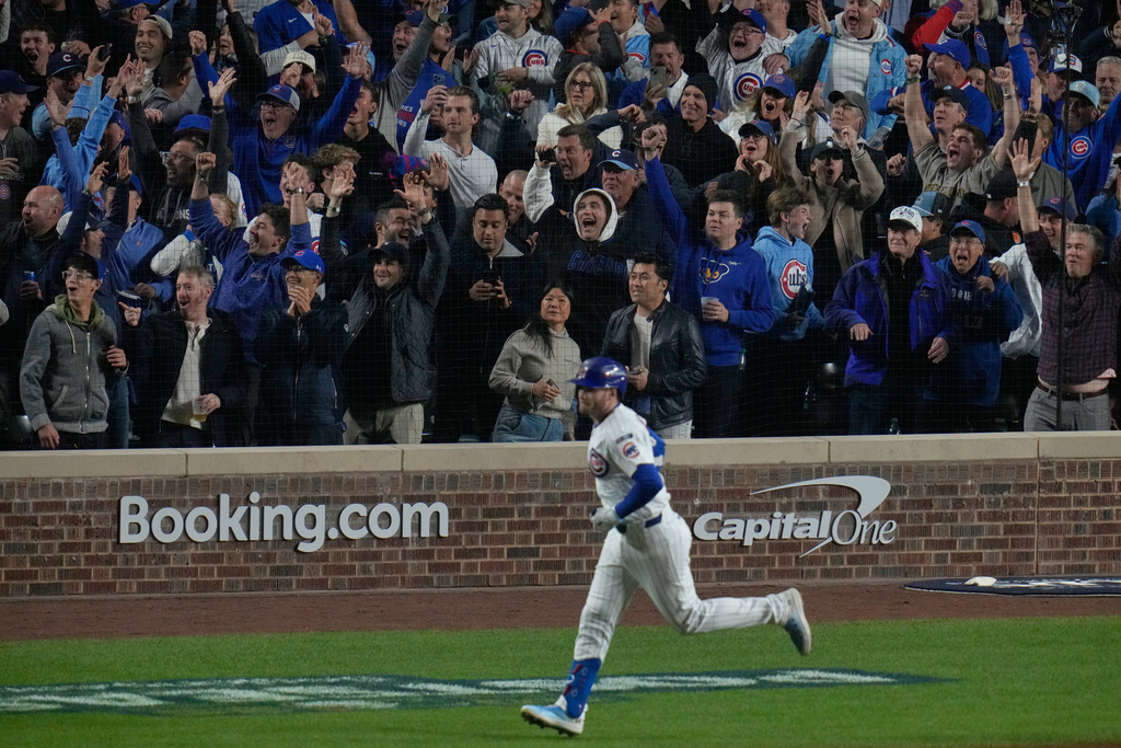 Chicago Cubs' Ian Happ (8) runs the bases after hitting a 3-run home run during the first inning of Game 4 of baseball's National League Division Series against the Milwaukee Brewers Thursday, Oct. 9, 2025, in Chicago. (AP Photo/Erin Hooley)