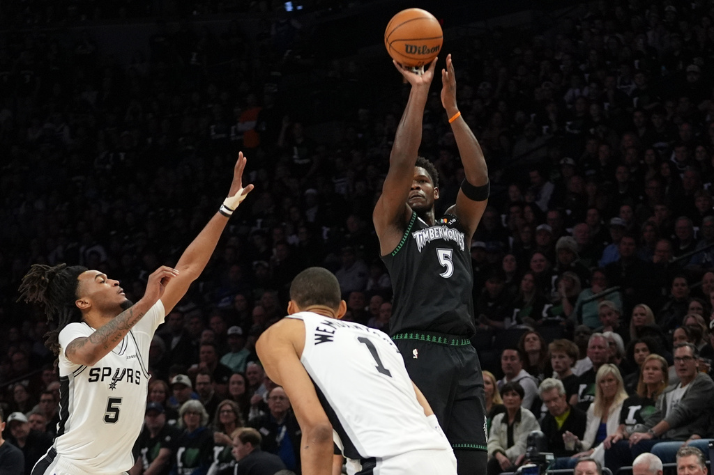 Minnesota Timberwolves guard Anthony Edwards (5) shoots over San Antonio Spurs forward Victor Wembanyama (1) and guard Stephon Castle (5) during the first half of Game 3 of a NBA basketball second-round playoff series in Minneapolis, Friday, May 8, 2026. (AP Photo/Abbie Parr)