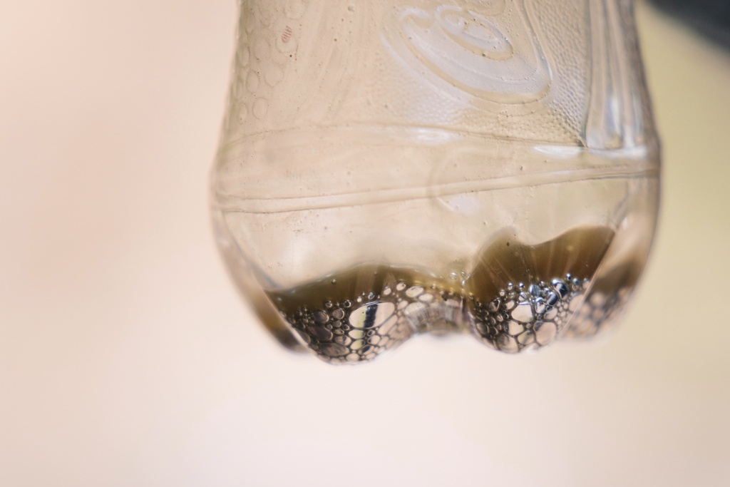 A sample of mercury is displayed in a Coca-Cola bottle in San Joaquin, Mexico, Tuesday, Aug. 19, 2025. (AP Photo/Fernando Llano)