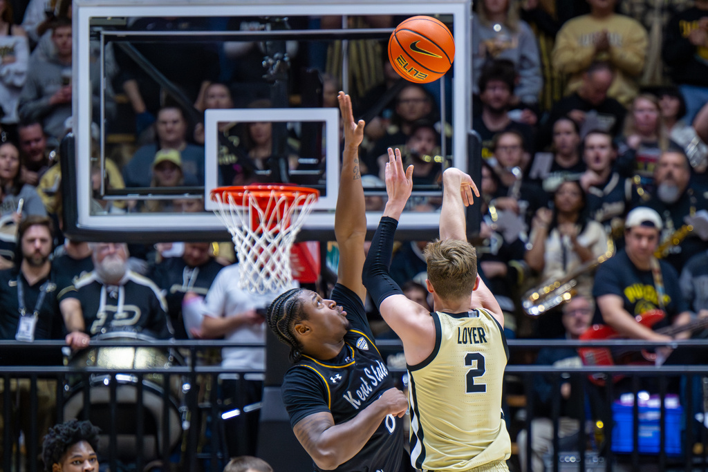 Kent State guard Morgan Safford, left, reaches for a shot by Purdue guard Fletcher Loyer (2) during the first half of an NCAA college basketball game, Monday, Dec. 29, 2025, in West Lafayette, Ind. (AP Photo/Doug McSchooler)