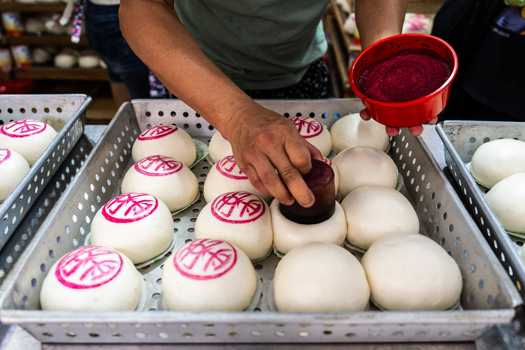 "Ping On" buns are prepared for sale for the Bun Festival in Cheung Chau Island in Hong Kong, Sunday, May 24, 2026. (AP Photo/Chan Long Hei)