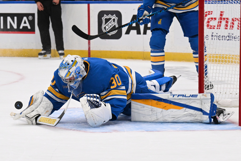 St. Louis Blues goaltender Joel Hofer (30) blocks a shot during the first period of an NHL hockey game against the Tampa Bay Lightning, Friday, Jan. 16, 2026, in St. Louis. (AP Photo/Connor Hamilton)