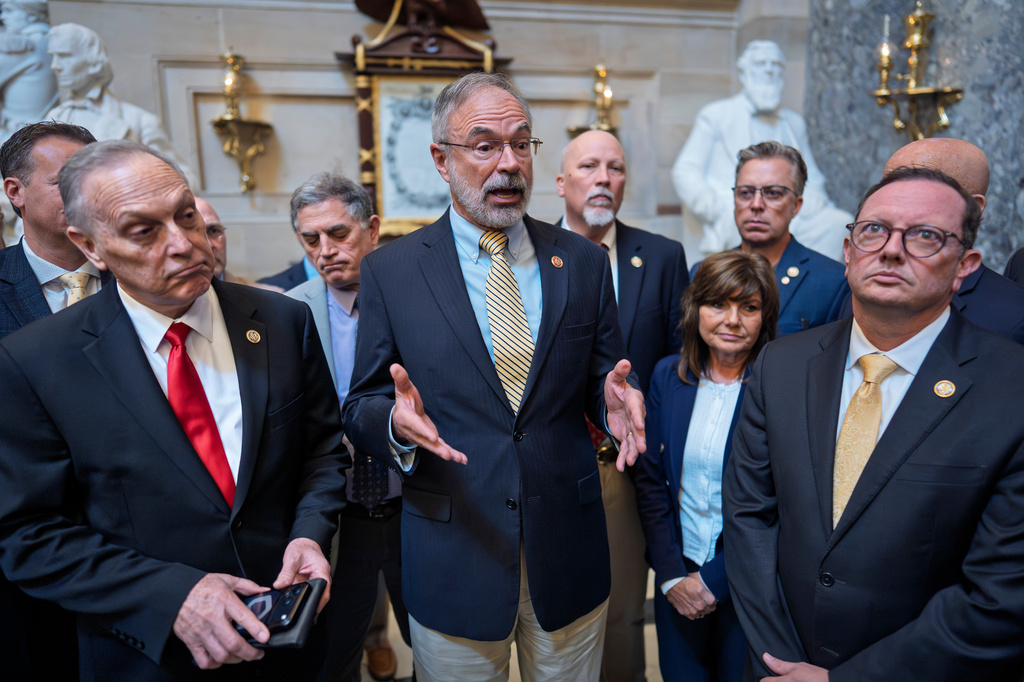 After a deal was approved to fund the Department of Homeland Security, except for immigration operations, members of the conservative House Freedom Caucus, including Rep. Andy Biggs, R-Ariz., left, and Rep. Andy Harris, R-Md., center, tell reporters that they won't vote in the House to pass it as is, at the Capitol in Washington, Friday, March 27, 2026. (AP Photo/J. Scott Applewhite)